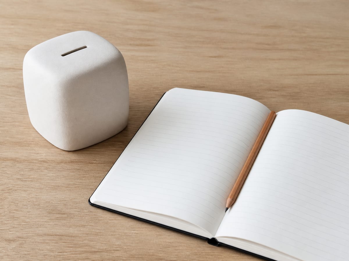 Three marketing proposals laid side by side on a desk, each annotated by hand with the same five headings: fee, media, software, setup, our hours