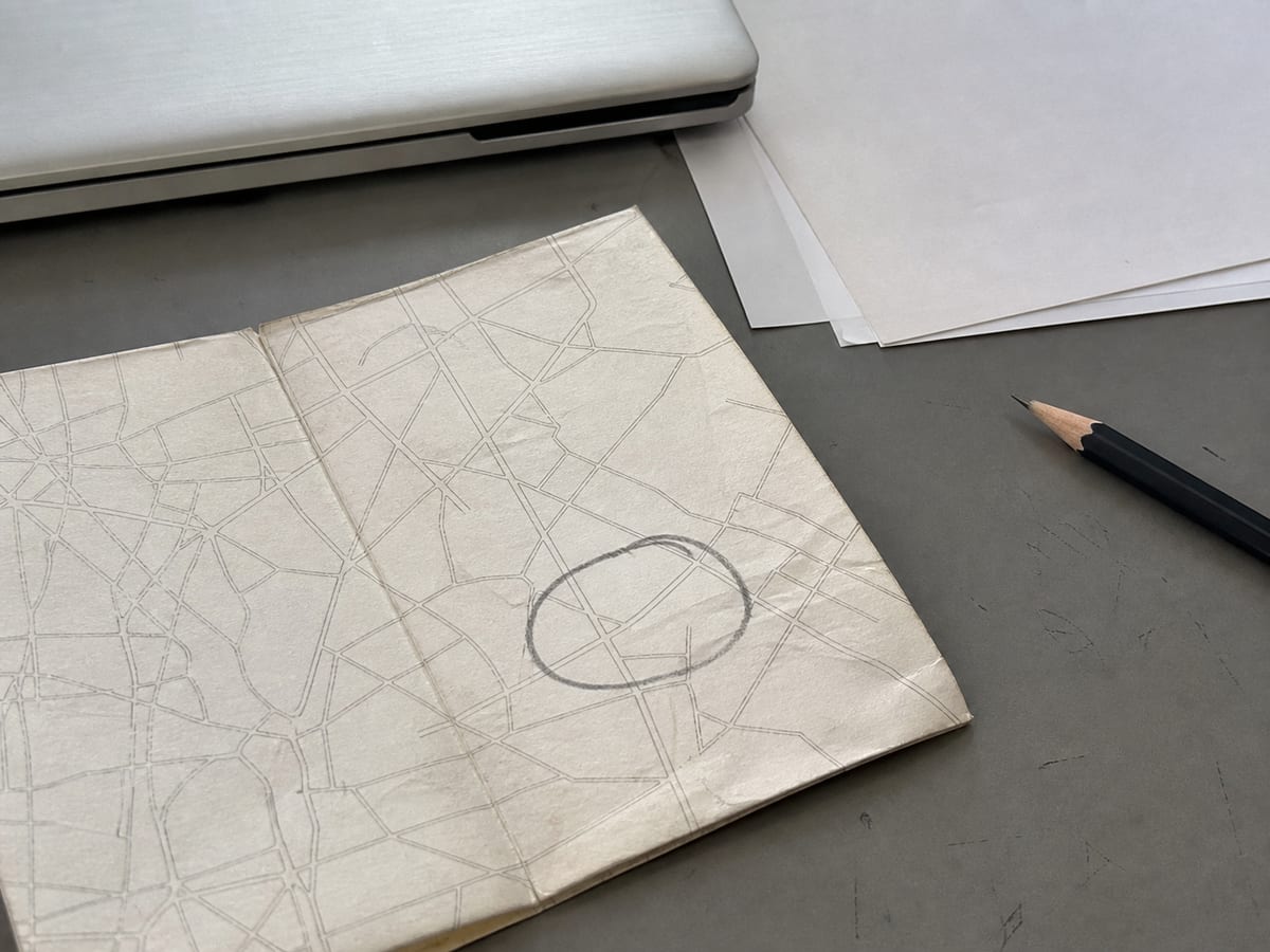 A corner of the same paper street map with one small area ringed once in pencil, the ring loose and hand-drawn